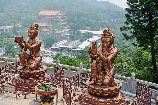 Buddhistic statues The Offering of Six Devas praising and making offer to Tian Tan Buddha. Ngong Ping. Lantau Island. Hong Kong.