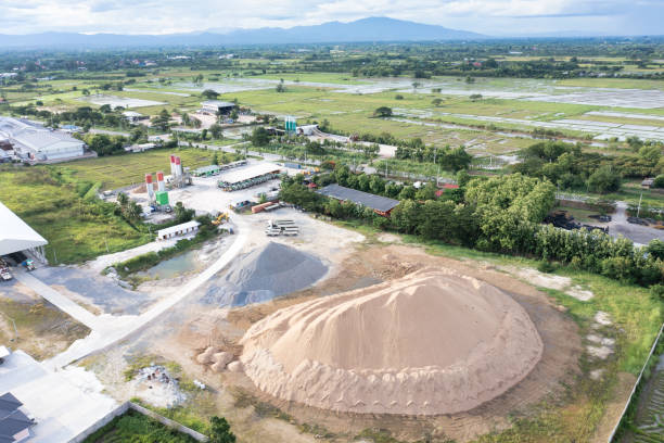 Pile of sand, gravel and concrete plant in aerial view. Pile of sand and rock or gravel in concrete plant with sky background in aerial view. Heap of aggregate or material from nature, mine or quarry for mix with cement, concrete for industry construction. Construction Silica Sand stock pictures, royalty-free photos & images