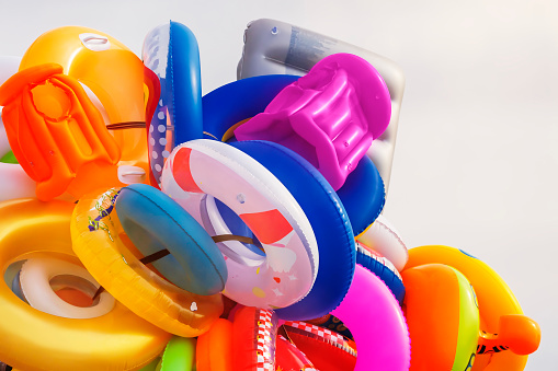A bunch of various rubber rings and inflatable beach toys for swimming close-up