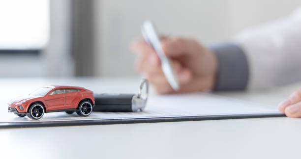 Car dealers or insurance managers cover and protect against damage Car dealers or insurance managers cover and protect against damage and the risk of driving, Protecting and after-sales care concept. car finance stock pictures, royalty-free photos & images