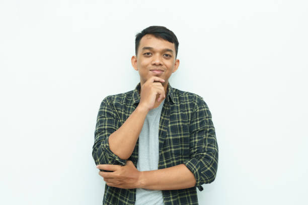 istock Young Asian man smiling and put hand on his chin 1482515568