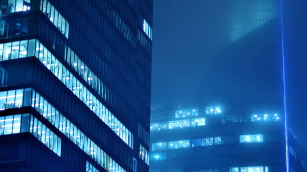 istock Pattern of office buildings windows illuminated at night. 1482519702