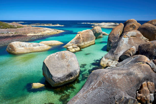 Granite boulders provide protected swimming area on ocean beach at Denmark Western Australia