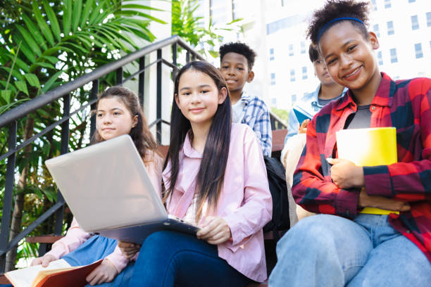 istock Diverse group of college students using laptops on campus, popular search, diverse college students 1482521335