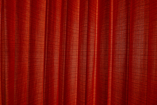 Background of closed fabric pattern red curtain, theater, performance.