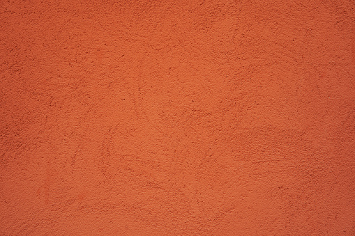 High resolution orange wall texture background, pattern, collage, wallpaper... Image of textured stucco in bright terracotta color.