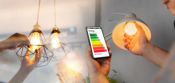 istock Man change a new electric bulb, hand using remote control open air conditioning 26 degrees make a home more energy efficient. Home appliance energy efficient. 1482527889