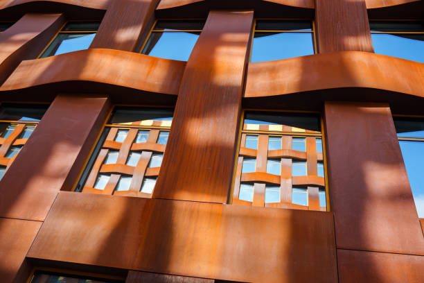 istock The brown facade of a stylish business building with modern architecture with a grid pattern against a blue sky. 1482535352