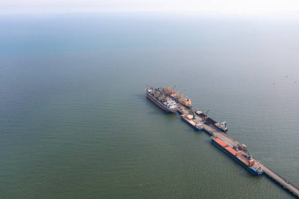 istock Cargo ship unloading from freight train in a commercial port. 1482535660