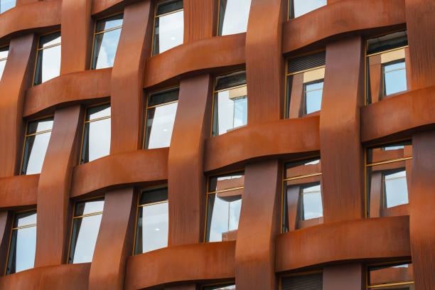 istock The brown facade of a stylish business building with modern architecture with a grid pattern against a blue sky. 1482535854