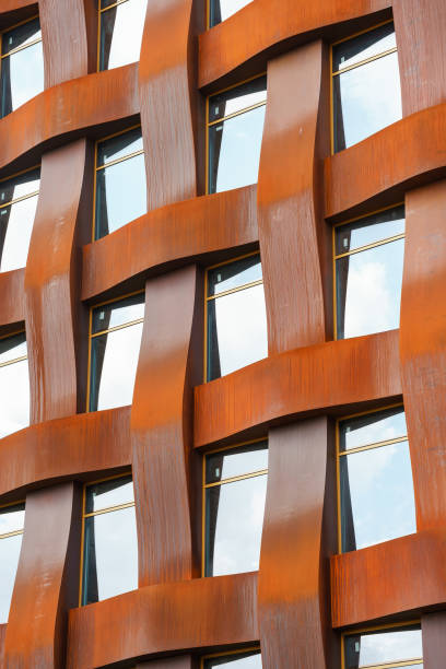 istock The brown facade of a stylish business building with modern architecture with a grid pattern against a blue sky. 1482536447