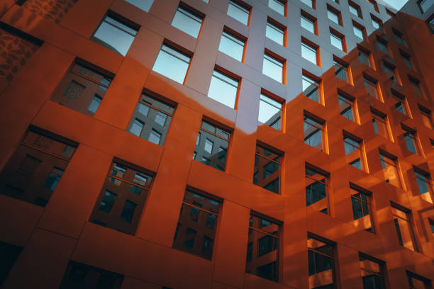 istock The brown facade of a stylish business building with modern architecture with a grid pattern against a blue sky. 1482536537