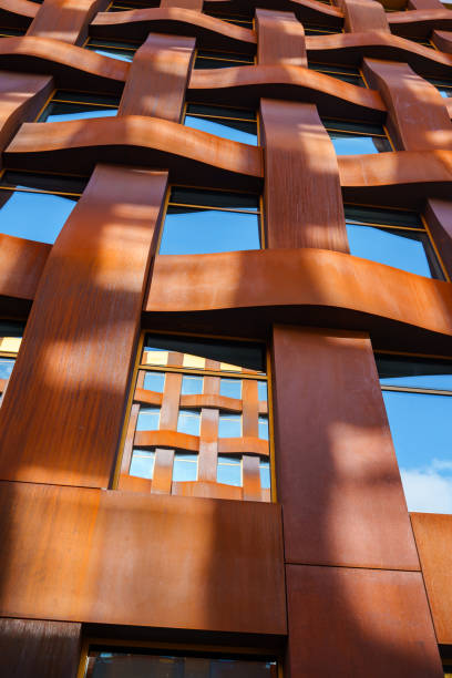 istock The brown facade of a stylish business building with modern architecture with a grid pattern against a blue sky. 1482536587