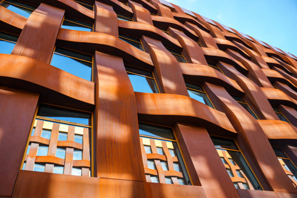 istock The brown facade of a stylish business building with modern architecture with a grid pattern against a blue sky. 1482536606