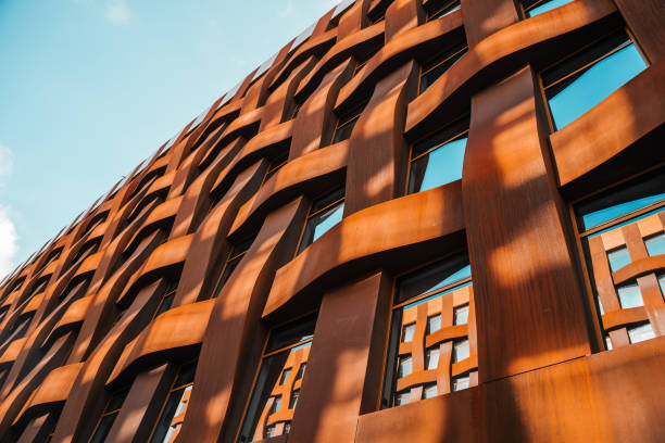 istock The brown facade of a stylish business building with modern architecture with a grid pattern against a blue sky. 1482536623