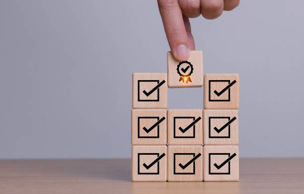 istock Corporate regulatory and compliance. Quality control management, ISO certification. Product, service quality warranty. Checklist survey and assessment process. Wooden cube with check mark icon 1482538816