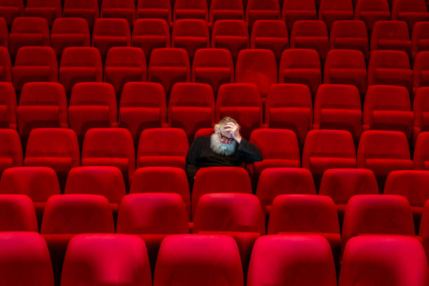 istock Concept frustration: One man  sits in Empty cinema or theatre. 1482539528