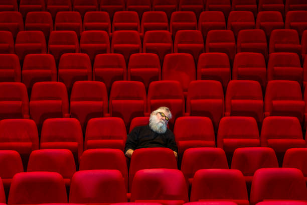 istock Concept boredom:One man  sits in Empty cinema or theatre, sleeping 1482539561