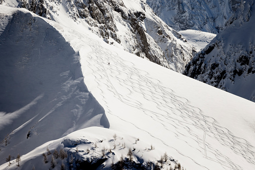 Skiers and snowboarders in Hochgurgl ski resort, backdropped by the Ötztal valley and the snow capped alpine mountains in Tyrol, Austria on a beautiful sunny day, perfect conditions for winter sports.