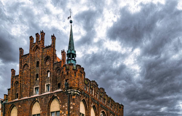 Beautiful old brick gothic church on the background of the stormy sky