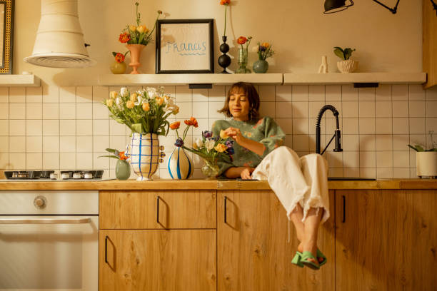 istock woman with flowers on kitchen 1482541153