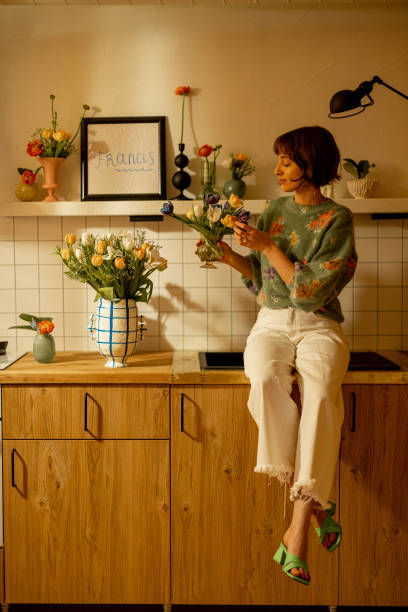 istock woman with flowers on kitchen 1482541872
