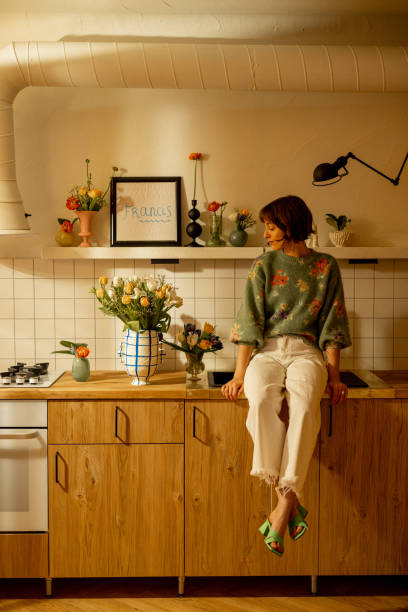 istock woman with flowers on kitchen 1482541891