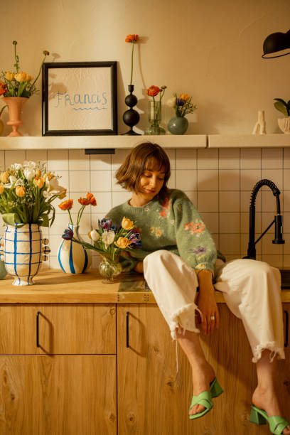 istock woman with flowers on kitchen 1482541911