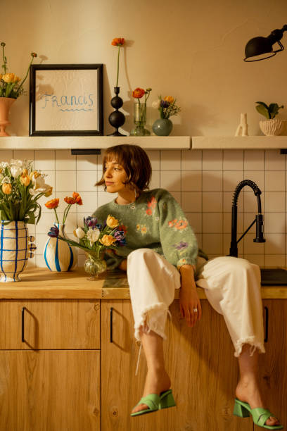 istock woman with flowers on kitchen 1482541932