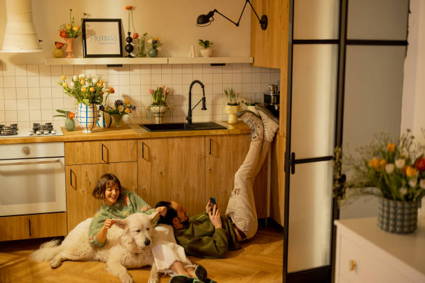 istock Couple with dog on kitchen at home 1482542973