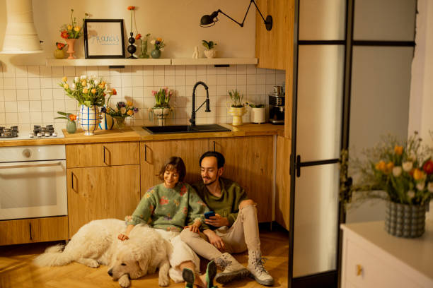 istock Couple with dog on kitchen at home 1482543011