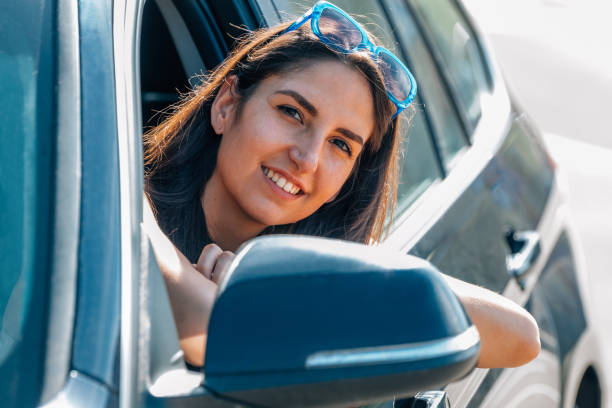 istock girl in the car driving 1482543146