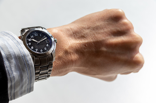 Vintage wrist watch on man's arm, close up