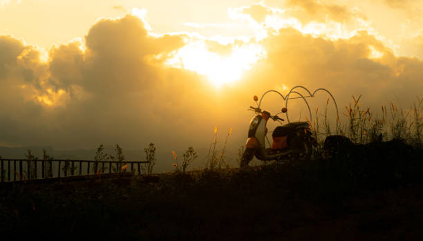 istock silhouette of motorcycle on mountain view with sunlight 1482544758