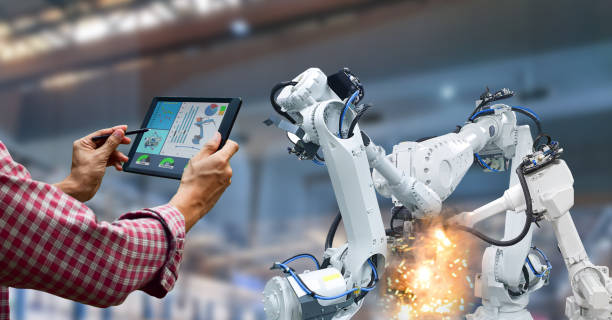 istock Industrial robot operator in factory holding tablet 1482544760