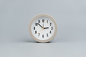 Alarm clock on gray background. Time concept. Meaning of time.