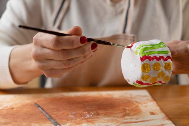 istock Female hands painting a pottery 1482547134