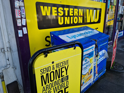 London. UK- 01.29.2021. Signs for Western Union money transfer service outside a retail store.