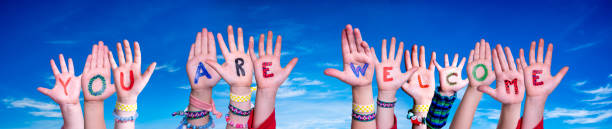 istock Children Hands Building Word You Are Welcome, Blue Sky 1482549963