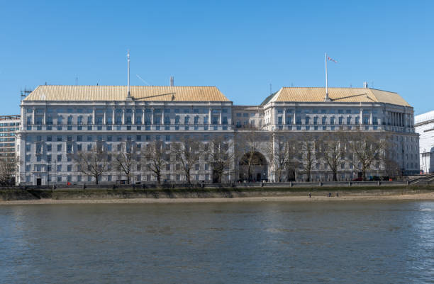 Victoria Embankment, London, England, UK, 22 April 2025: Daytime spring/summer urban view of central London cityscape along the River Thames. Thames buildings, the river, boats, and riverside walkways are partially visible. Clear sunny weather and bright daylight.