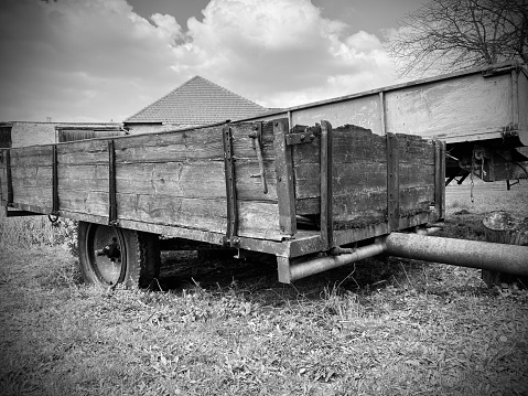 Old wooden farm trailer, rustic, black nad white, retro farming equipment.
