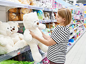 Woman in toy store buys big bear