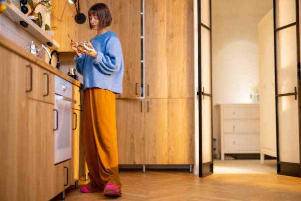 istock Woman has a breakfast on stylish kitchen interior 1482561000