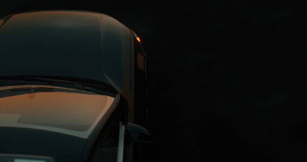 Khmelnytskiy, Ukraine - July 11, 2020: A sleek black sports car is parked in front of a modern glass building, reflecting the vibrant city life.