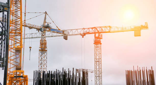 istock Tower cranes on the background of the cooling tower. 1482565960