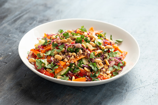 Asian Quinoa salad with fresh vegetables, peanuts and herbs. Healthy food