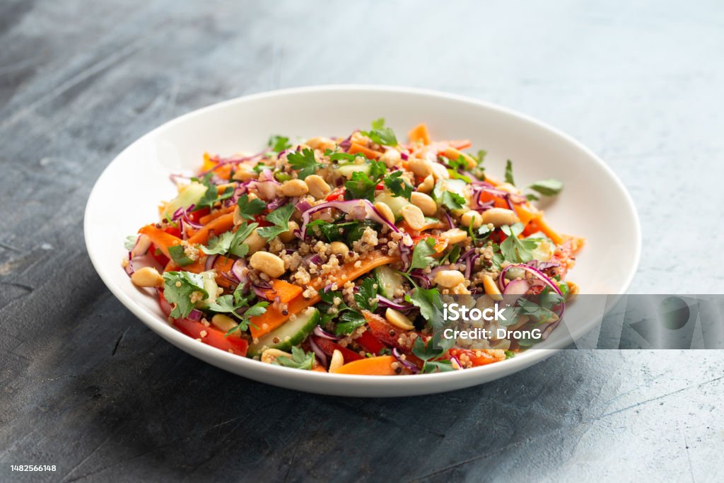 Asian Quinoa salad with fresh vegetables, peanuts and herbs. Healthy food. Asian Quinoa salad with fresh vegetables, peanuts and herbs. Healthy food Vegetarian Food Stock Photo