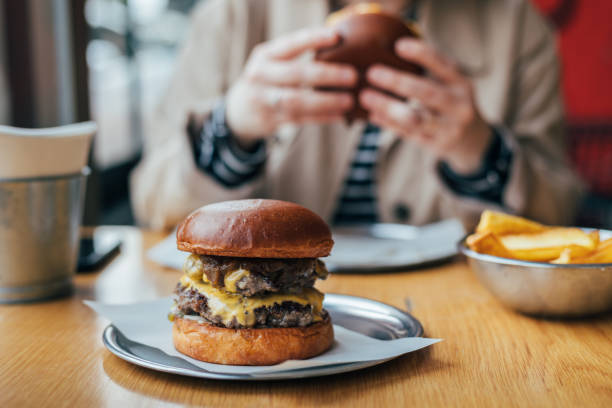 Woman eating delicious burger