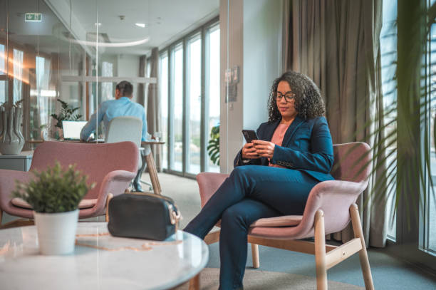 istock Hispanic Female Job Applicant Using Smartphone In An Office Lobby 1482570249