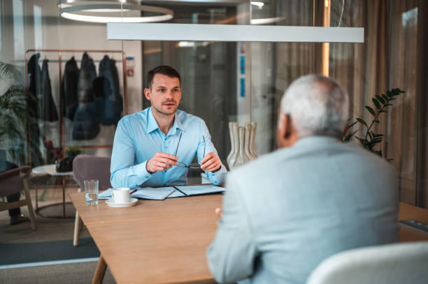 istock Caucasian Human Resources Manager Interviewing A Mature Hispanic Job Candidate 1482570289